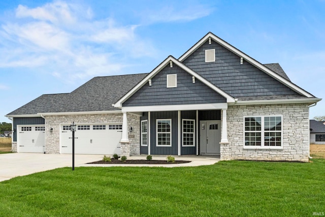 craftsman inspired home with a garage and a front yard