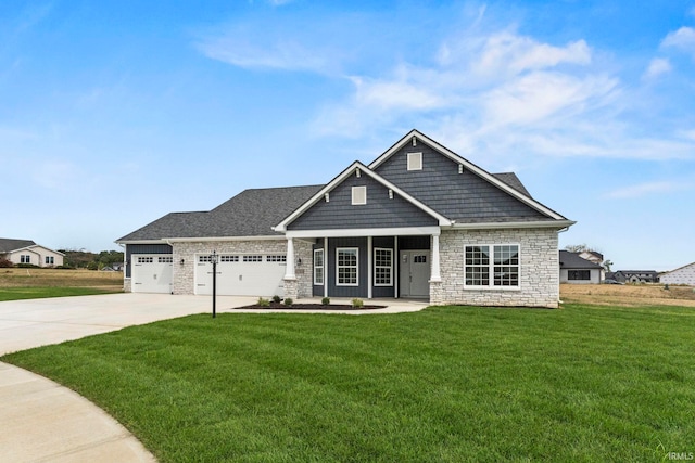 craftsman house with a front yard and a garage