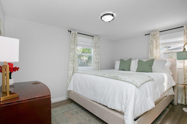 bedroom with dark wood-type flooring