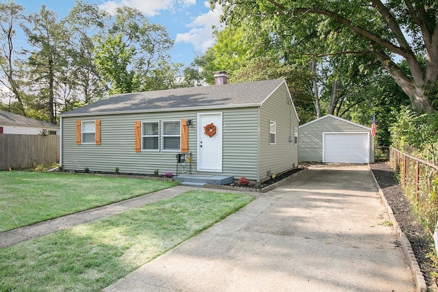 view of front of home featuring a garage, an outdoor structure, and a front yard