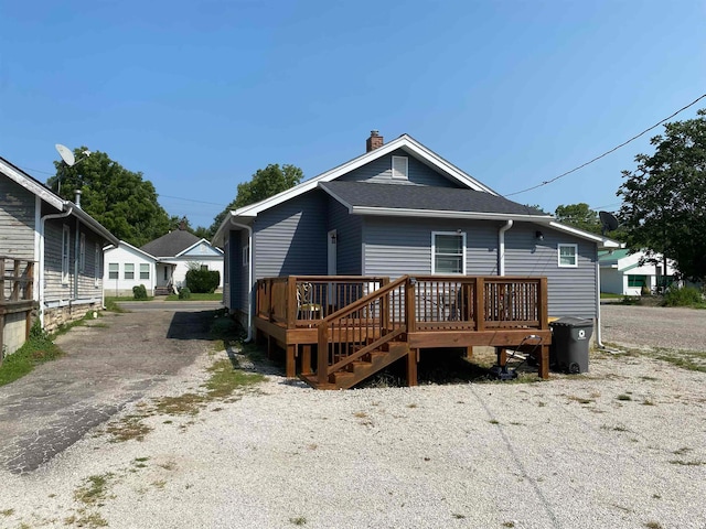 back of house featuring a wooden deck