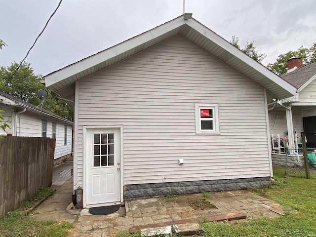 rear view of property with fence