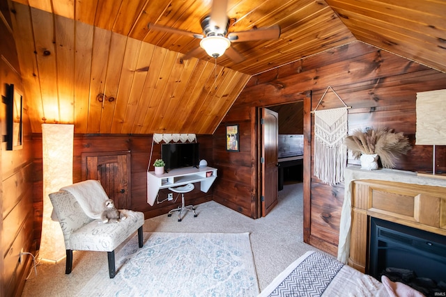 office featuring light carpet, wood walls, vaulted ceiling, ceiling fan, and wood ceiling