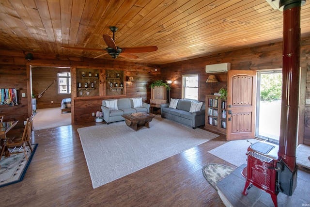 living room with a wall mounted AC, ceiling fan, hardwood / wood-style flooring, and wooden ceiling