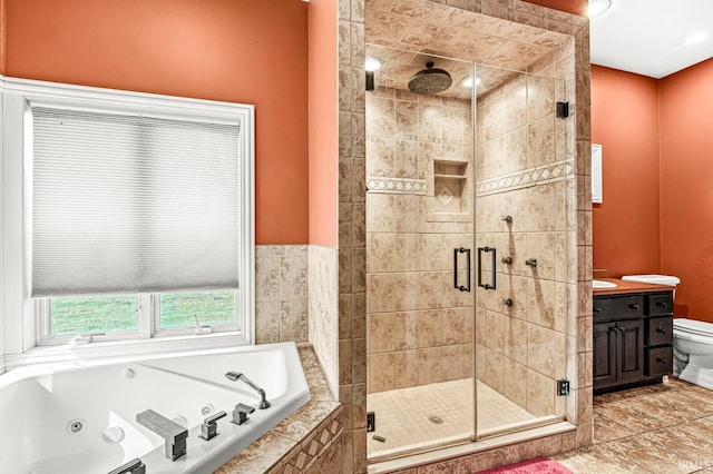 full bathroom with vanity, separate shower and tub, and toilet