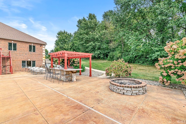 view of patio / terrace with a pergola and an outdoor fire pit