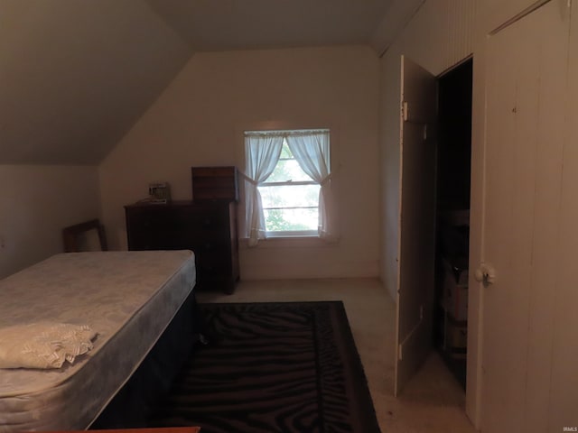 carpeted bedroom featuring vaulted ceiling