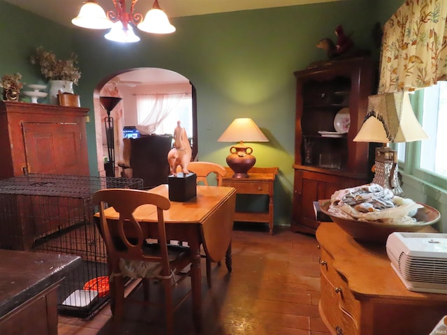 dining space with a notable chandelier and hardwood / wood-style flooring