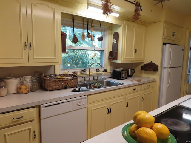 kitchen featuring sink and white appliances