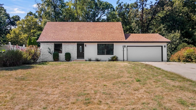 view of front of property with a garage and a front lawn