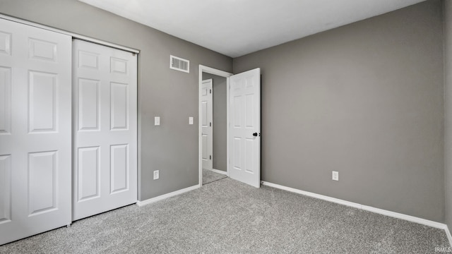 unfurnished bedroom featuring a closet and light carpet