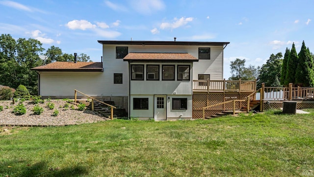 rear view of property with a wooden deck and a yard