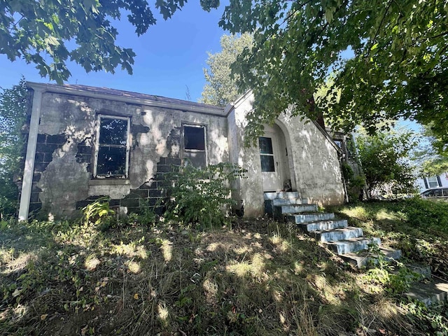 rear view of house with stucco siding