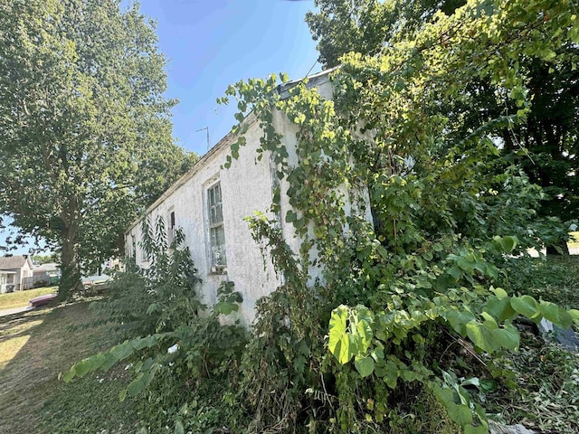 view of side of property featuring stucco siding