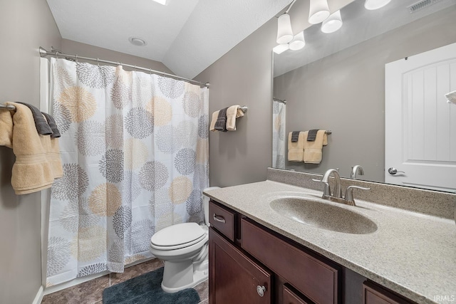 bathroom with walk in shower, vanity, toilet, and vaulted ceiling