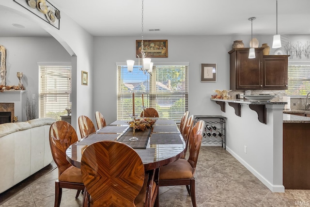 dining area featuring plenty of natural light, a chandelier, and light tile patterned floors