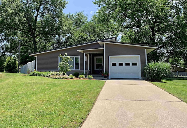 ranch-style home with a garage and a front yard