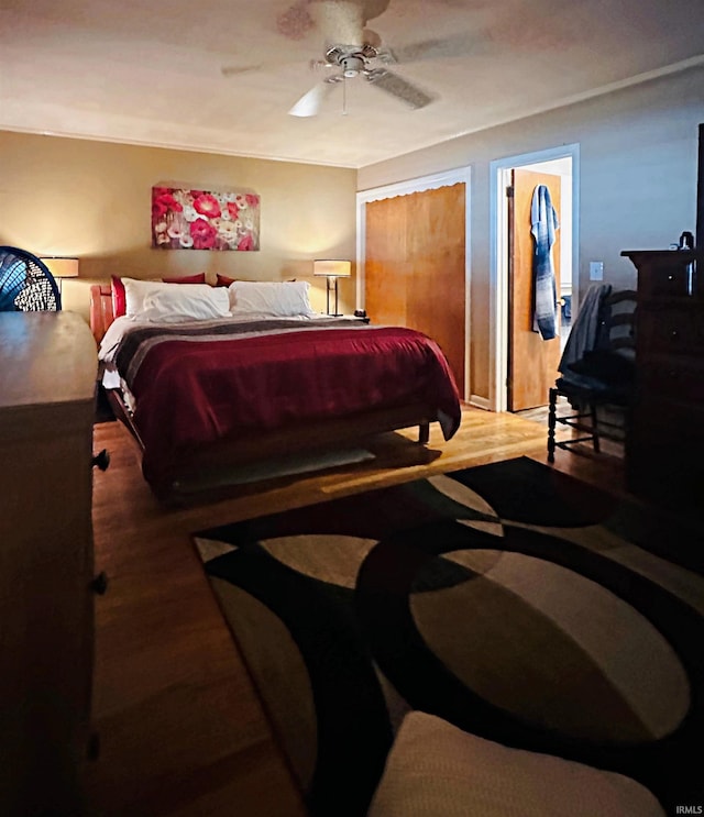 bedroom with hardwood / wood-style floors and ceiling fan