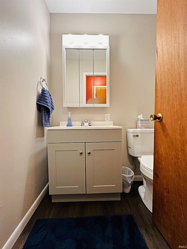 bathroom featuring vanity, toilet, and wood-type flooring