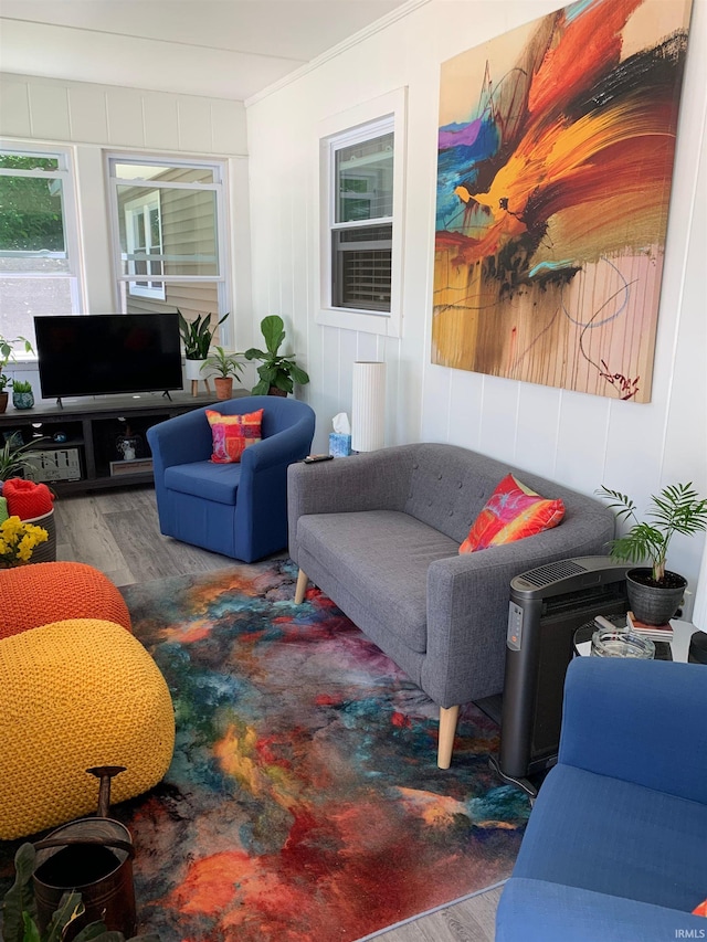 living room featuring ornamental molding and hardwood / wood-style flooring