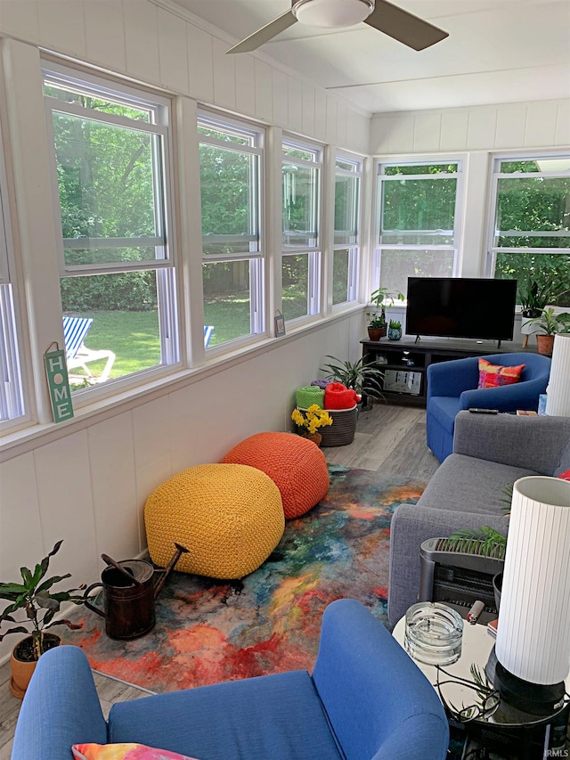 sunroom with a healthy amount of sunlight and ceiling fan