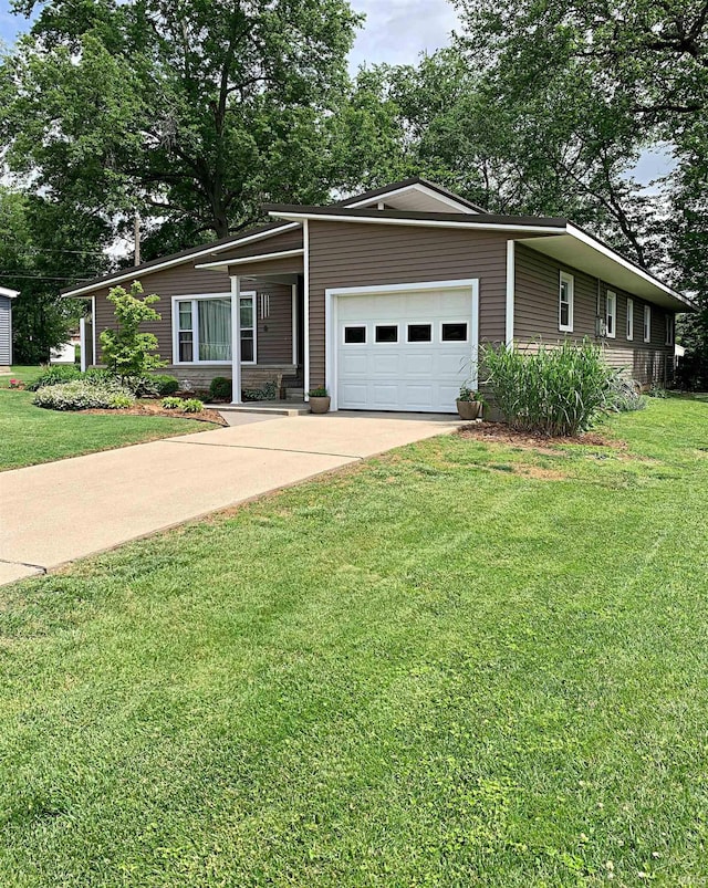 view of front of house featuring a garage and a front lawn