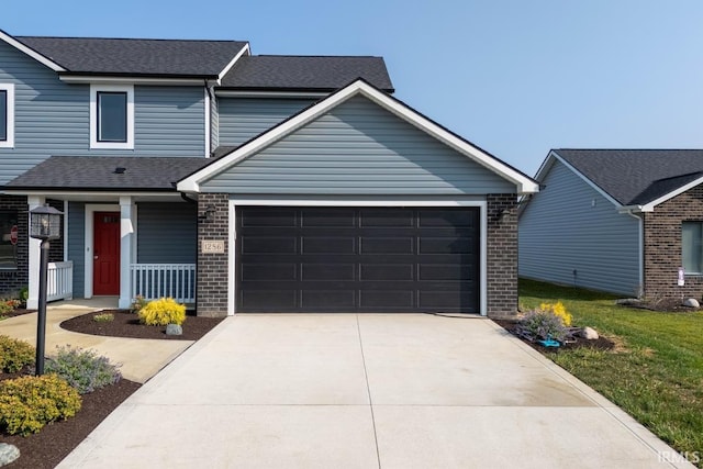 view of front of home featuring a porch and a garage