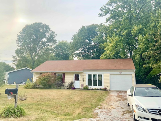 single story home featuring a garage and a front lawn