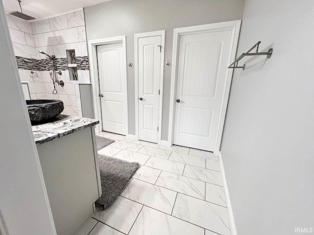 bathroom with vanity and tiled shower