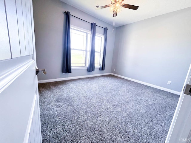 carpeted spare room featuring ceiling fan