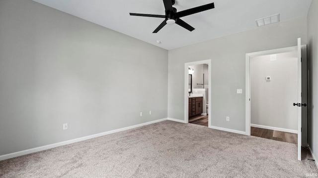 unfurnished bedroom featuring connected bathroom, ceiling fan, and carpet