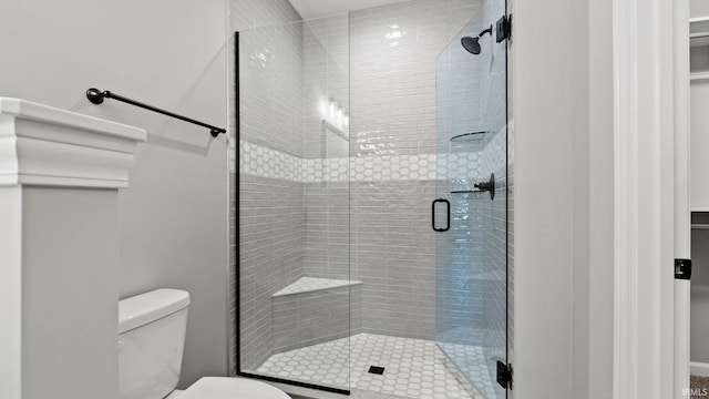 bathroom featuring toilet and walk in shower