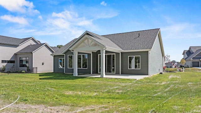 back of property featuring a yard and a patio area