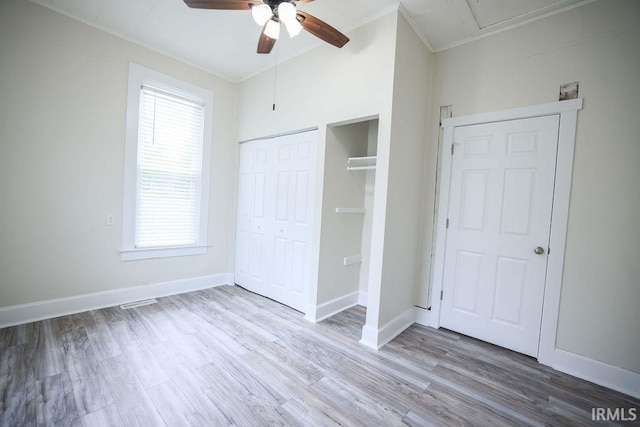 unfurnished bedroom with hardwood / wood-style floors, ceiling fan, and ornamental molding