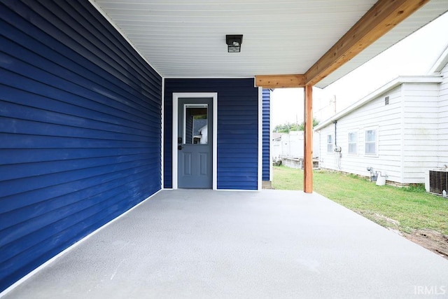 exterior space with central AC and a yard