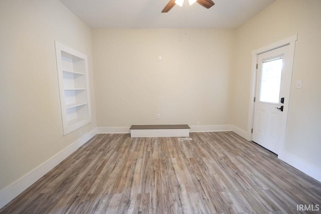 foyer entrance with light hardwood / wood-style flooring and ceiling fan