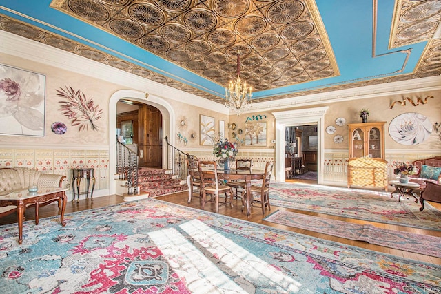 interior space with hardwood / wood-style flooring, a notable chandelier, and a towering ceiling