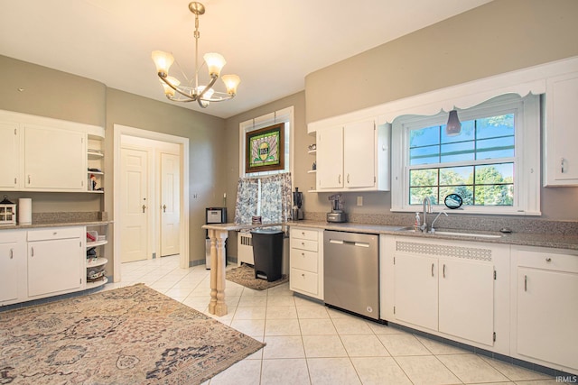 kitchen with decorative light fixtures, stainless steel dishwasher, sink, a chandelier, and white cabinetry