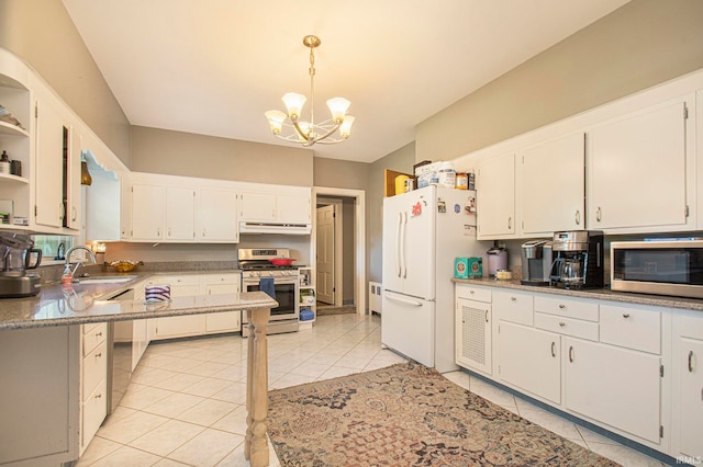 kitchen with hanging light fixtures, stainless steel appliances, and white cabinetry