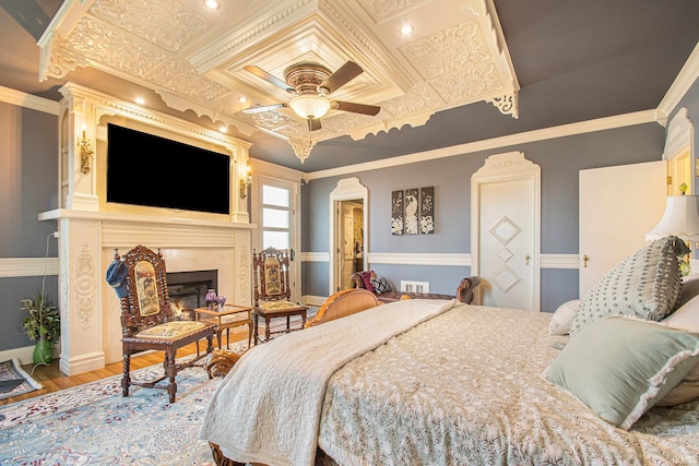 bedroom featuring crown molding, hardwood / wood-style floors, and ceiling fan