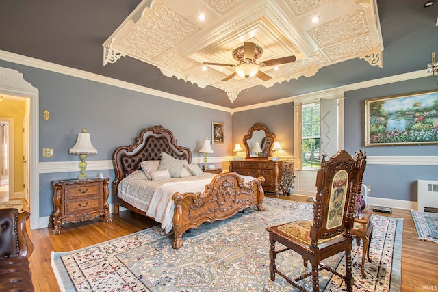 bedroom featuring ceiling fan, hardwood / wood-style flooring, and ornamental molding