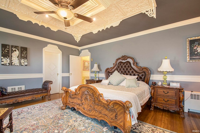 bedroom featuring crown molding, ceiling fan, radiator heating unit, and wood-type flooring