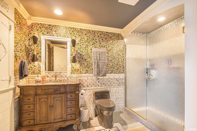 bathroom with an enclosed shower, crown molding, toilet, tile walls, and vanity