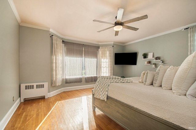 bedroom featuring crown molding, radiator, light hardwood / wood-style flooring, and ceiling fan