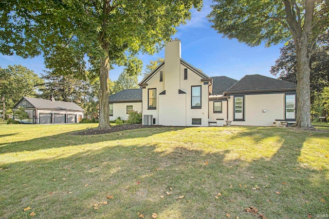 rear view of property featuring a yard and central AC unit