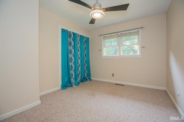 carpeted empty room with ceiling fan