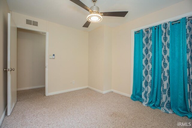 spare room with carpet and ceiling fan