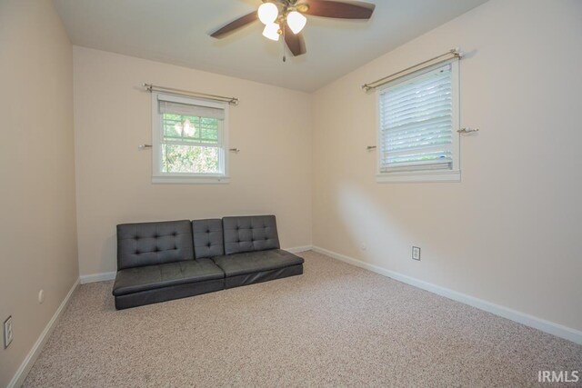 unfurnished room featuring ceiling fan and carpet floors