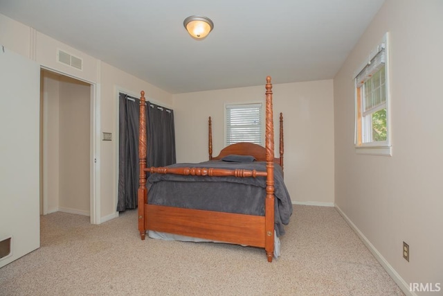 bedroom featuring light carpet