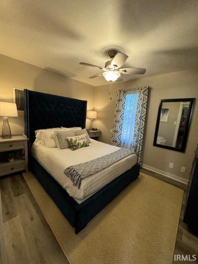 bedroom featuring dark wood-type flooring and ceiling fan